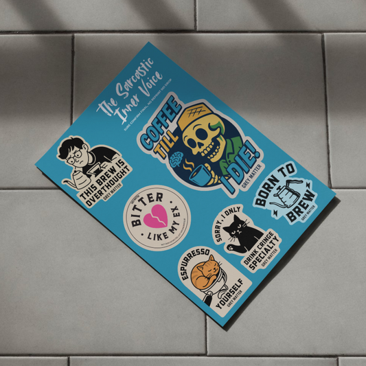 Collection of coffee-themed stickers on a blue card against a tiled wall background
