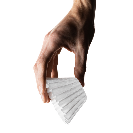 Hand holding a stack of white paper strips against a white background